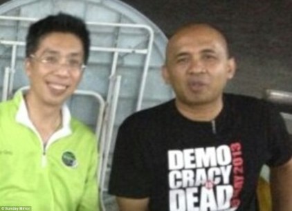 Peter Chong (left) with best friend Captain Zaharie Ahmad Shah, pilot of the missing Malaysia Airlines plane. He is pictured in a T-shirt with a Democracy is Dead slogan as police investigate claims he could have hijacked the plane as an anti-government protest. Image courtesy of DailyMail.co.uk. 